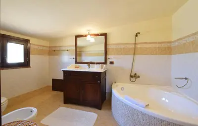 a bathroom with a tub and a sink and a mirror at Beautiful Home In Altavilla Milicia in Altavilla Milicia