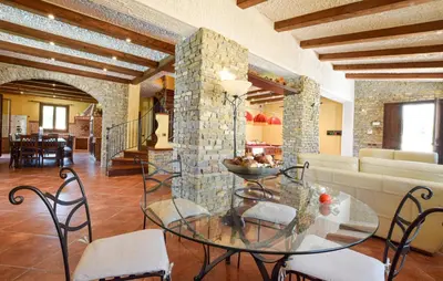 a living room with a glass table and chairs at Beautiful Home In Altavilla Milicia in Altavilla Milicia
