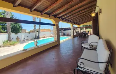 a patio with chairs and a swimming pool at Beautiful Home In Altavilla Milicia in Altavilla Milicia