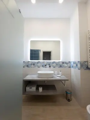 a bathroom with a sink and a mirror at Light Charme, Sea Light Apartment a due passi dalla PIAZZA DUOMO in Terrasini