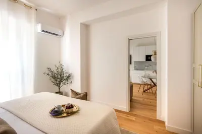 a kitchen and dining room with a glass table and chairs at Lo Jacono Apartments by Wonderful Italy in Palermo