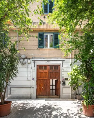 a hallway with a wooden door in a house at Lo Jacono Apartments by Wonderful Italy in Palermo