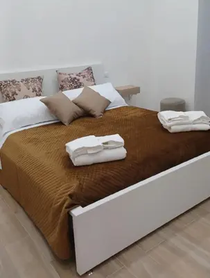 a large bed with towels on top of it at CasaIniso' in Palermo
