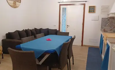 a living room with a blue table and a couch at CasaIniso' in Palermo