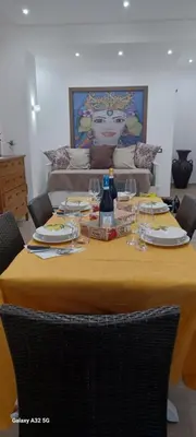 a table with plates and wine glasses on it at CasaIniso' in Palermo