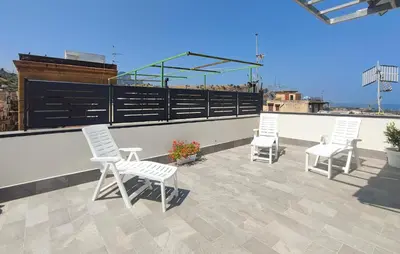 three white chairs sitting on top of a roof at Awesome Apartment In Capaci With Wifi in Capaci