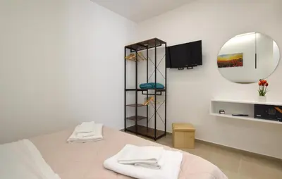 a bedroom with a mirror and a bed with towels at Awesome Apartment In Capaci With Wifi in Capaci