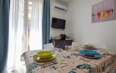 a dining room table with plates and bowls on it at Awesome Apartment In Capaci With Wifi in Capaci