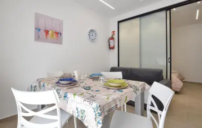 a dining room with a table and white chairs at Awesome Apartment In Capaci With Wifi in Capaci