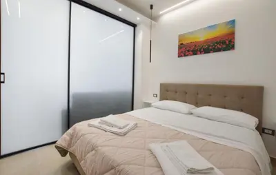 a bedroom with a large bed with two towels on it at Awesome Apartment In Capaci With Wifi in Capaci