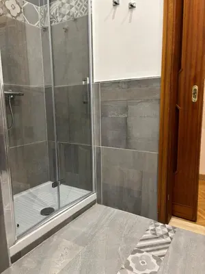 a shower with a glass door in a bathroom at House La Cantinetta in Palermo
