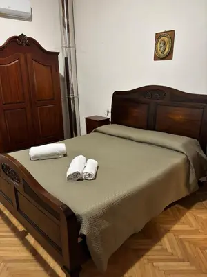 a bed with two towels on top of it at House La Cantinetta in Palermo