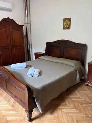 a bedroom with a bed with two towels on it at House La Cantinetta in Palermo