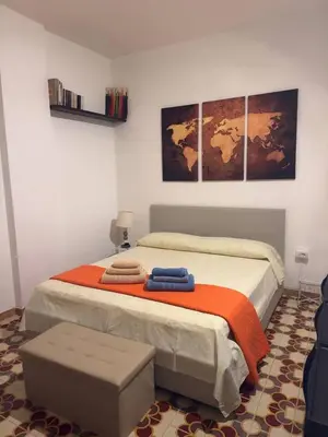 a bedroom with a bed with two towels on it at Emma's Beach Apartment in Isola delle Femmine
