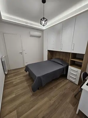 a bedroom with a bed and white cabinets at Palermo Francia in Palermo