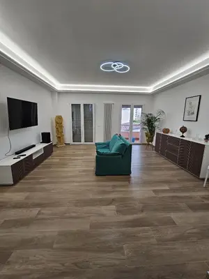 a living room with a green couch and a flat screen tv at Palermo Francia in Palermo