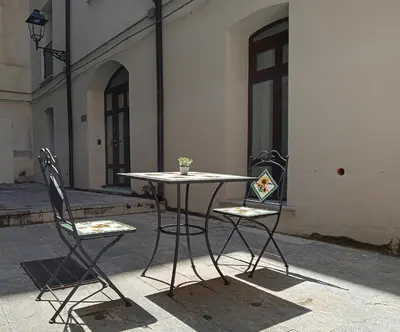 a table and two chairs in front of a building at Diana ai Quattro Canti - centro storico Palermo in Palermo