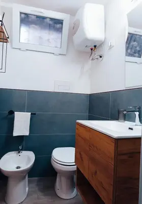 a bathroom with a toilet and a sink at Diana ai Quattro Canti - centro storico Palermo in Palermo