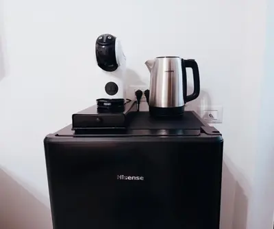 a coffee maker sitting on top of a refrigerator at Diana ai Quattro Canti - centro storico Palermo in Palermo