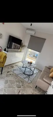 a living room with a table and a couch at Dagma Spa Home Sicilia in Carini