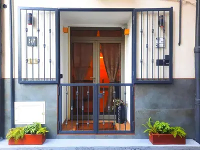 an entrance to a building with wrought iron gates at D'Halya 57 in Palermo