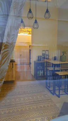 a reflection of a room with a table and chairs at D'Halya 57 in Palermo