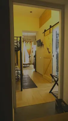 a room with a door open to a room with a bedroom at D'Halya 57 in Palermo