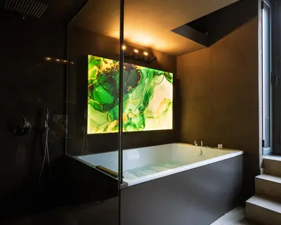 a bathroom with a tub with a painting on the wall at Cattedrale Suite in Palermo
