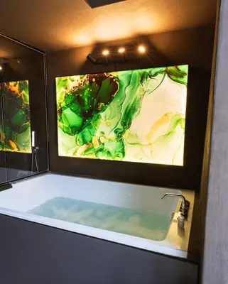 a bathroom with a tub with two large screens at Cattedrale Suite in Palermo
