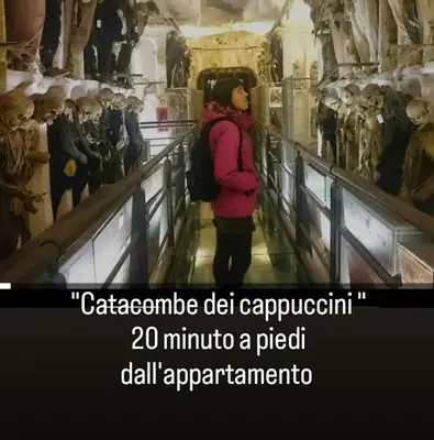 a woman walking down a hallway in a museum at Love nest cathedral ,in the heart of the city in Palermo