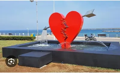 a fountain with two red hearts in the water at Casa Monteserrato in Terrasini