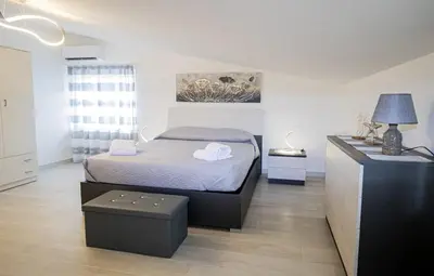 a bedroom with a bed and a dresser in it at Villa degli Ulivi in Partinico