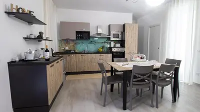 a kitchen with a table and chairs in a room at Villa degli Ulivi in Partinico