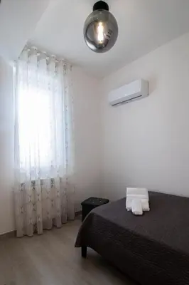 a bedroom with a bed and a window at Villa degli Ulivi in Partinico