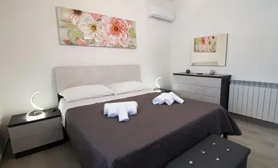 a bedroom with a bed with two towels on it at Villa degli Ulivi in Partinico
