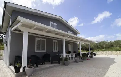 a house with a patio with tables and chairs at Villa degli Ulivi in Partinico