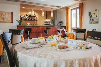 a table with a white table cloth with food on it at Hotel Costa Azul in Balestrate