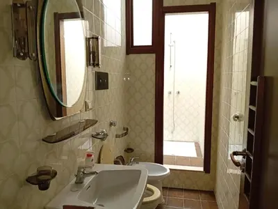 a bathroom with a sink and a toilet and a mirror at Aurooms in Cinisi