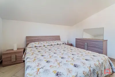a bedroom with a bed and a dresser and a mirror at Villa with private Pool in Castellammare dei Golfo in Castellammare del Golfo