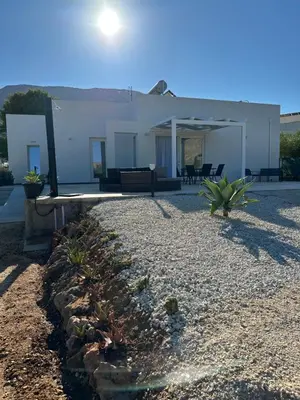 a house with a gravel yard in front of it at Villa Tosto in Castelluzzo