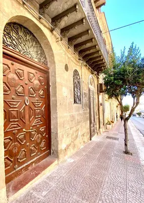 a large wooden door on the side of a building at Palazzo 700 in Castellammare del Golfo