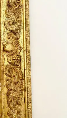 a gold frame with a fancy design on a wall at Palazzo 700 in Castellammare del Golfo