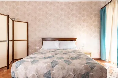 a bedroom with a bed with a patterned wall at GuestHost - La Maison Real Palermo in Palermo