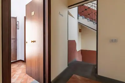 a hallway with a door and a stairway at GuestHost - La Maison Real Palermo in Palermo