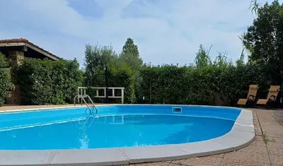 a large blue swimming pool in a yard at Heaven House Sicily in Carini