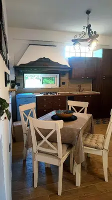 a kitchen with a table and chairs in a kitchen at Heaven House Sicily in Carini