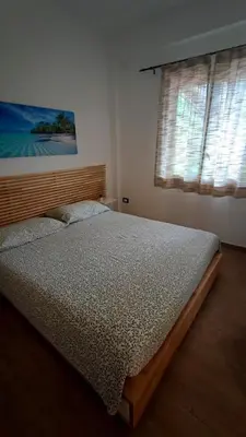 a bedroom with a bed and a large window at Heaven House Sicily in Carini
