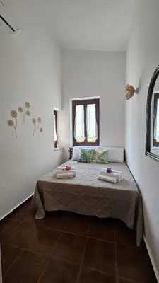 a bedroom with a large bed in a room at Villa del Faro, Capo Zafferano in Santa Flavia