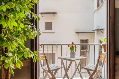a balcony with a table and chairs on a balcony at GuestHost - Central Apartment Palermo in Palermo