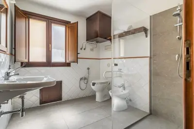 a bathroom with a toilet and a sink and a shower at GuestHost - Central Apartment Palermo in Palermo